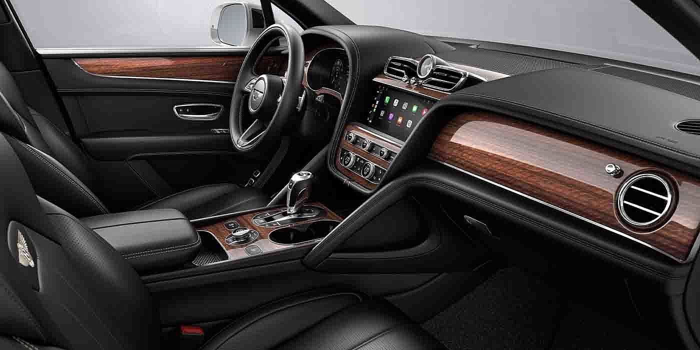 Bentley Beijing-Yizhuang Bentley Bentayga EWB interior with a Crown Cut Walnut veneer, view from the passenger seat over looking the driver's seat.